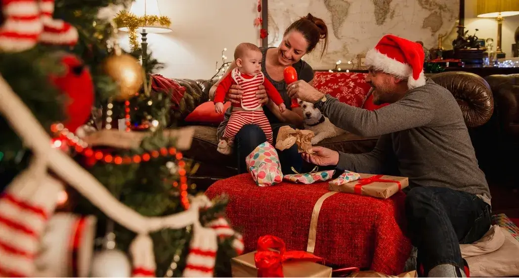 Family enjoying Christmas morning in a cozy living room with gifts and festive decor
